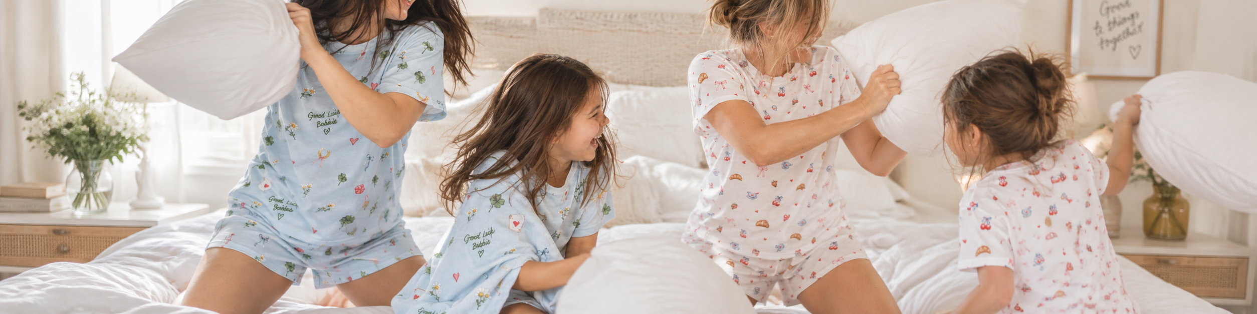A playful pillow fight in Good Luck Bobbie and Breakfast in Bed pajamas